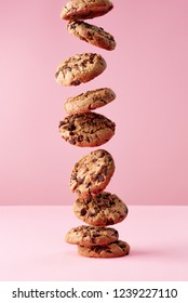 Chocolate Chip Cookies Falling In Stack On Pink Background, Food Levitation