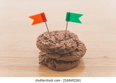 Chocolate Chip Cookies With Green And Red Flag On Wooden Table Background Copy Space. Cookies Website Internet Homepage Policy Accepted Or Blocks Concept.