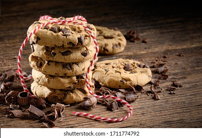 Chocolate chip cookies stack on old wooden table. Rustic style