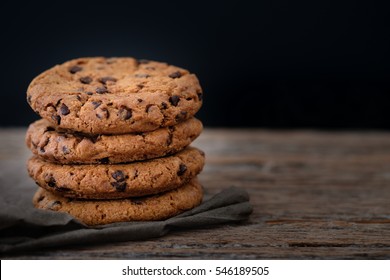 Chocolate chip cookies stacked up on a plate in low light, 
AF point selection - Powered by Shutterstock