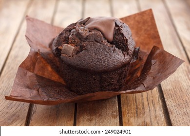 Chocolate Chip Muffin In Brown Wax Paper. Unwrapped.