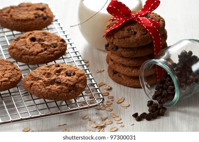 Chocolate Chip Oatmeal Cookies On A Cooling Rack With Ingredients