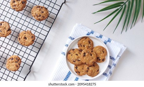 Chocolate chips cookies on the cooling rack. Sweet and delicious taste. Soft but crunchy. Top view. Flat lay. Minimalist and aesthetic food photography.  - Powered by Shutterstock