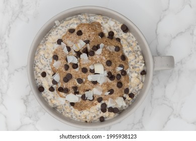 Chocolate Chips And Sliced Almonds On Top Of Oatmeal Ready To Eat In A Bowl On The Table Is A Great Way To Start The Day With A Good Source Of Fiber And Protein.