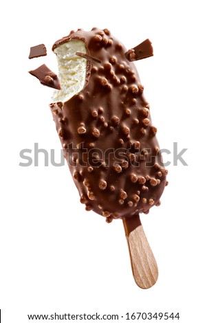 Chocolate coated ice cream with crisps on a stick and pieces of chocolate on a white background
