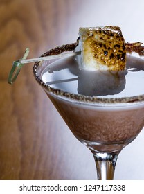 Chocolate Cocktail With Marshmallow Vodka Garnished With A Gram Cracker Rim And A Toasted Marshmallow