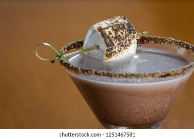 Chocolate Cocktail With Marshmallow Vodka Garnished With A Gram Cracker Rim And A Toasted Marshmallow