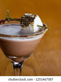 Chocolate Cocktail With Marshmallow Vodka Garnished With A Gram Cracker Rim And A Toasted Marshmallow