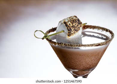 Chocolate Cocktail With Marshmallow Vodka Garnished With A Gram Cracker Rim And A Toasted Marshmallow