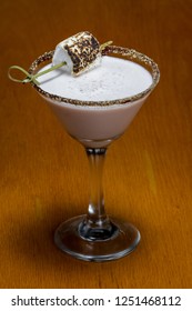 Chocolate Cocktail With Marshmallow Vodka Garnished With A Gram Cracker Rim And A Toasted Marshmallow