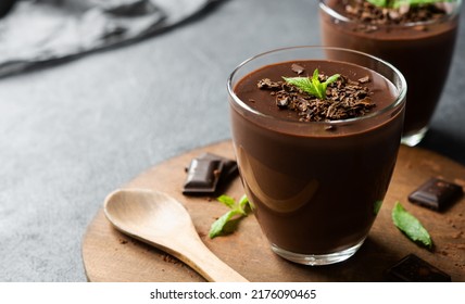 Chocolate cocoa pudding, mousse in glass cup on rustic table, supangle - Powered by Shutterstock
