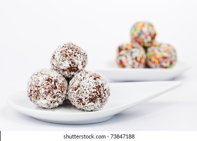 Chocolate And Coconut Truffles On A White Plate