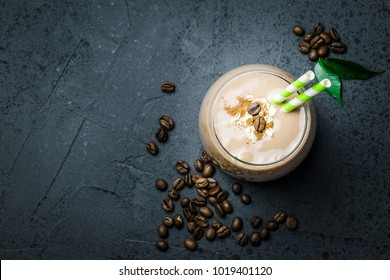 Chocolate Coffee Smoothie And Coffee Beans On Dark Concrete Background. Selective Focus, Space For Text. Top View, Space For Text, Close Up.