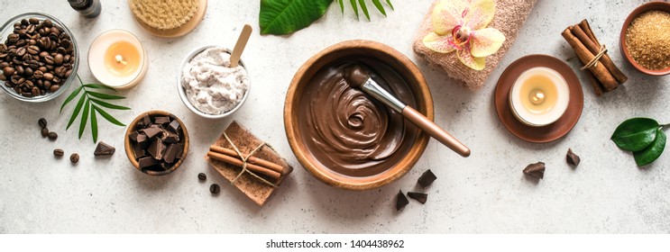 Chocolate and Coffee Spa flat lay on white background, top view, banner. Natural spa beauty products with coffee and chocolate.