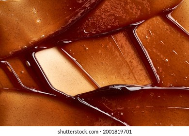 Chocolate colored gel smear and texture. Cosmetic gel or caramel syrup on white background