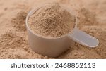 Chocolate colour protein, whey powder sprinkle in cup. Bodybuilding, fitness and gym lifestyle