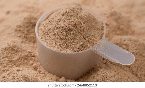 Chocolate colour protein, whey powder sprinkle in cup. Bodybuilding, fitness and gym lifestyle - Powered by Shutterstock