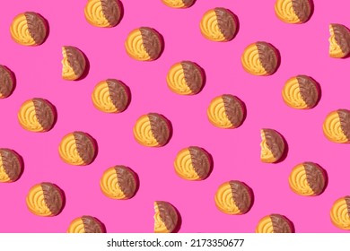 Chocolate Cookies Creative Pattern On Neon Pink Background.