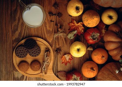 Chocolate Cookies, Vegetables, Fruit And Milk In A Mug. Baking With Cinnamon Sticks On A Wooden Background. Mug In The Shape Of A Heart. Autumn Composition. Apples And Persimmons, Fall Harvest.