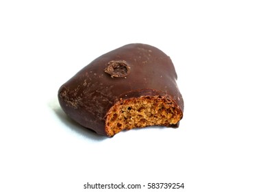 Chocolate Covered Gingerbread Heart With A Bite Mark On A White Background