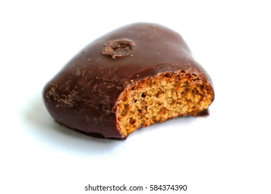 Chocolate Covered Gingerbread Heart With A Bite Mark On A White Background