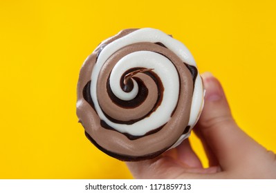 chocolate cream ice cream in waffle cone on yellow background. - Powered by Shutterstock