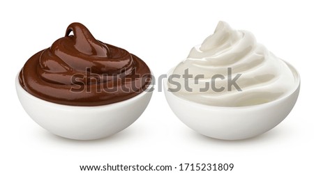 Chocolate cream and milk vanilla cream in bowl isolated on white background with clipping path, swirl of hazelnut paste
