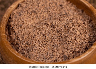 chocolate crumbs in a wooden bowl close up, round wooden bowl with chocolate pieces and chips - Powered by Shutterstock