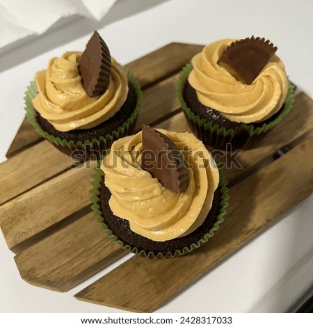 Chocolate cupcake topped with peanut butter buttercream and Reese’s peanut butter cups