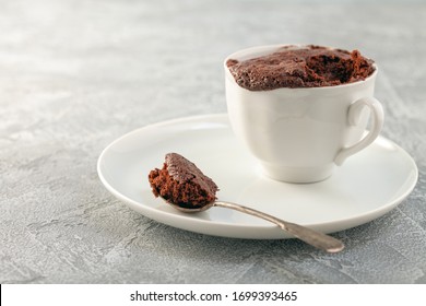 Chocolate cupcake in a white mug. Easy homemade dessert. Mugcake - Shutterstock ID 1699393465