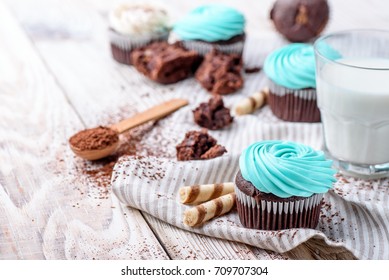 Chocolate cupcakes on white wood with milk, and cocoa