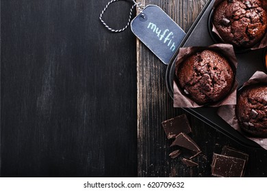 Chocolate Dark Muffin With  On A Old Black Wooden Table With  Chocolate. Overhead Shot With Copy Space.