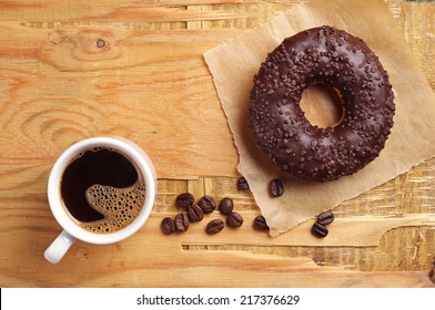 Chocolate Donut And Cup Of Hot Coffee On Vintage Wooden Background. Top View