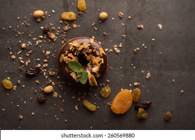 Chocolate Donut With Mint Leaf On Dark Stone Background 