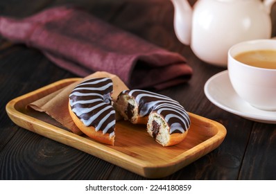 Chocolate donut on wooden plate - Shutterstock ID 2244180859