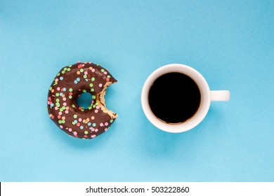 Chocolate donuts with coffee on the blue background. Delicious donut. - Powered by Shutterstock