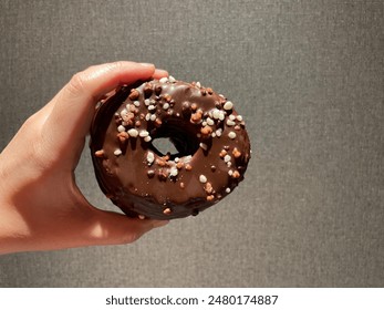 Chocolate donuts topped with nuts - Powered by Shutterstock