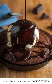 Chocolate Double Fudge Brownie, Ala Mode.  Homemade Brownie Topped With Vanilla Bean Ice Cream, Chocolate And Hot Chocolate Syrup. Action Shot.