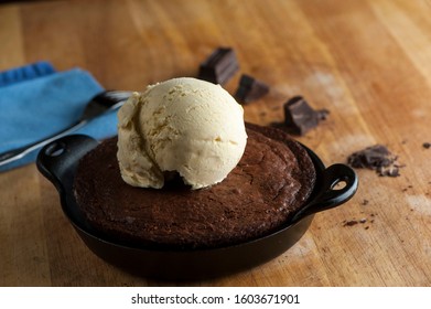 Chocolate Double Fudge Brownie, Ala Mode.  Homemade Brownie Topped With Vanilla Bean Ice Cream, Chocolate And Hot Chocolate Syrup. Action Shot.