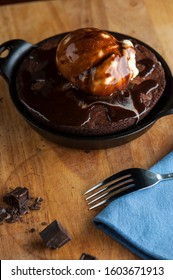 Chocolate Double Fudge Brownie, Ala Mode.  Homemade Brownie Topped With Vanilla Bean Ice Cream, Chocolate And Hot Chocolate Syrup. Action Shot.