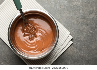 Chocolate dough and whisk in bowl on grey table, top view. Space for text - Powered by Shutterstock