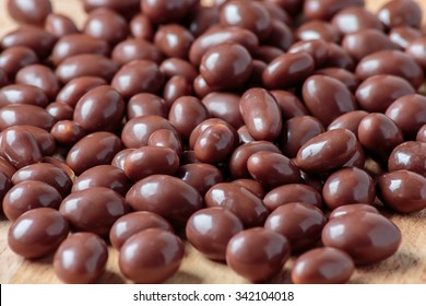 Chocolate dragee on wooden background