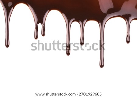 Chocolate drips elegantly down a white surface creating a visually stunning effect ideal for showcasing dessert recipes or promoting chocolate products with its rich color and smooth texture.