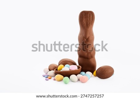 Chocolate easter bunny with decorated candy eggs
