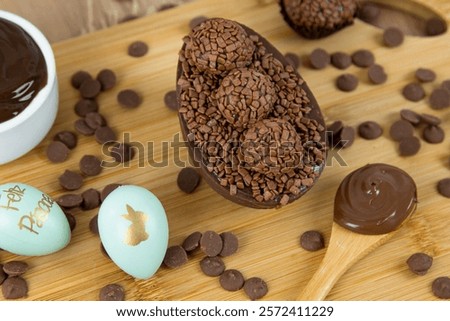 Chocolate Easter egg filled with chocolate ganache. Easter egg with brigadeiro. (Contains the phrase 