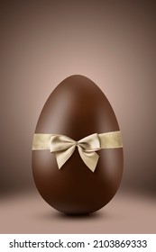 Chocolate Easter Egg With Gold Ribbon On Brown Background
