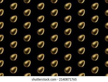 Chocolate easter egg pattern with gold foil on black background. Wallpaper. backdrop.