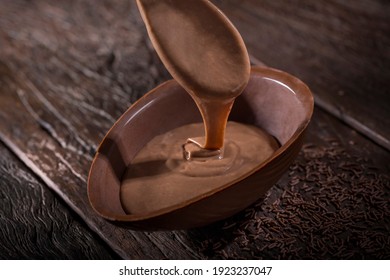 Chocolate Easter egg stuffed with chocolate sauce. - Powered by Shutterstock