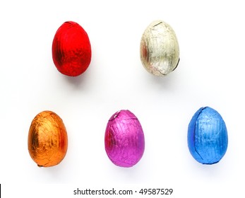 Chocolate Easter Egg Treats Each Wrapped In Shiny Colorful Foil On White