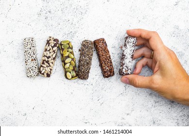 Chocolate Energy Protein Bars With Nuts, Seeds, Dry Fruits. Healthy Dietary Snack. Vegan Dessert. Woman Hand Hold Sweet Protein Bar.